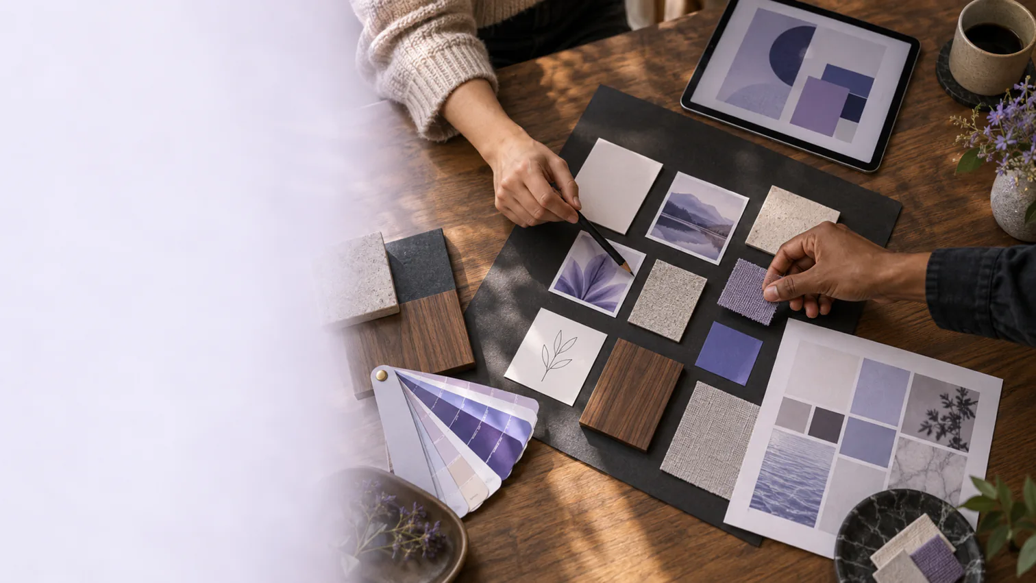 Two people refine a creative mood board with images, materials and color samples.