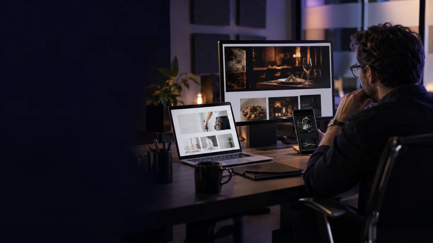 A creative director reviews restaurant, barbershop and service-business websites across several devices.