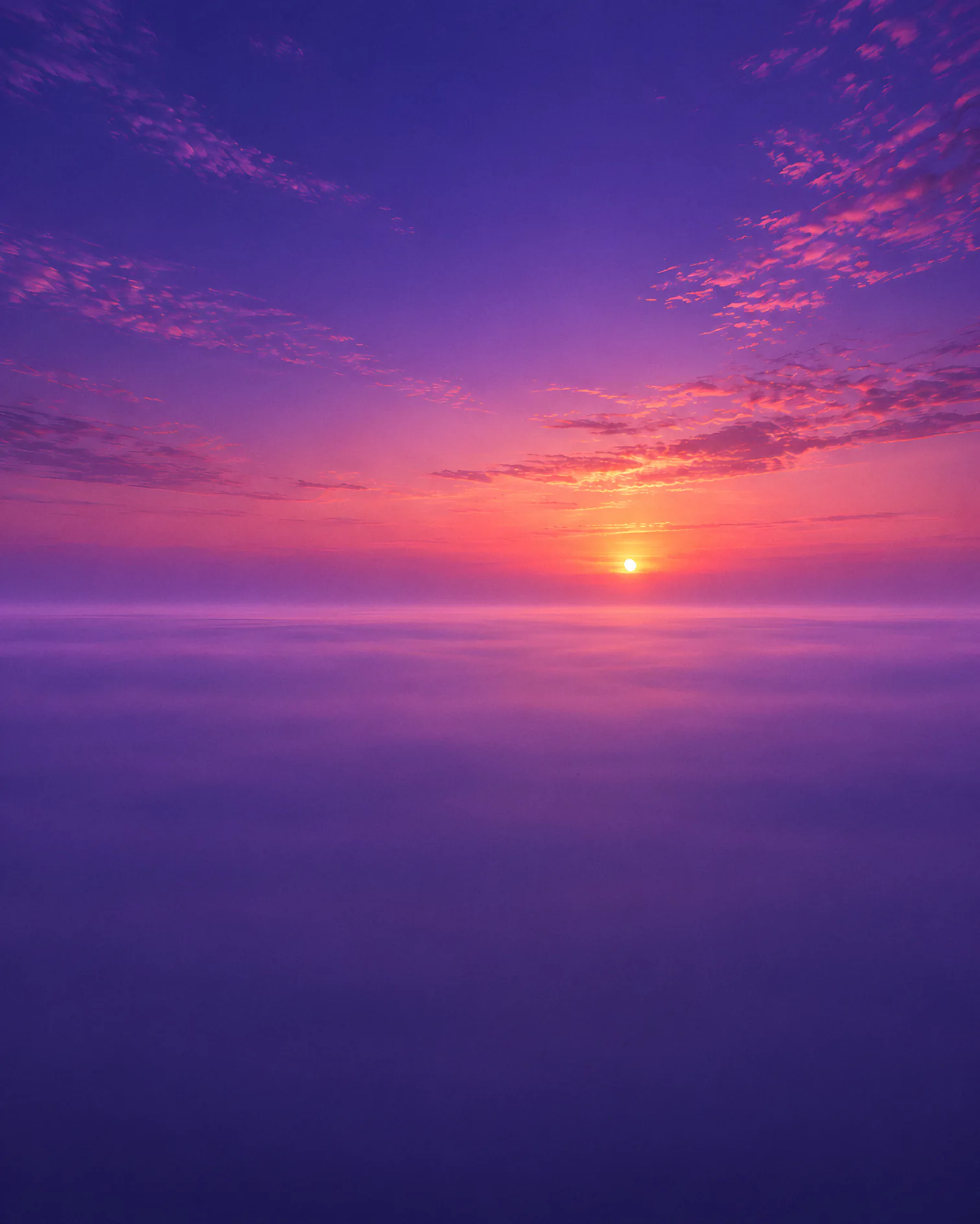 A wide dawn sky over a straight, misty horizon.